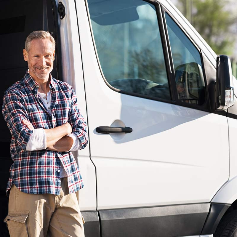 Happy customer in front of his white commercial van